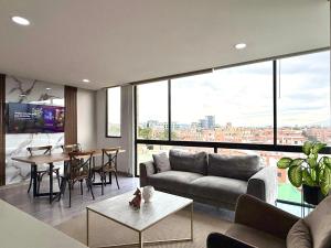a living room with a couch and a table at EspacioYa By Mario Rental Calle 100 in Bogotá