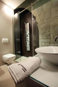 a bathroom with a sink and a toilet and a towel at Masseria Torre Di Nebbia in Castel del Monte +30 photos