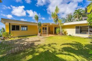a house with palm trees in front of it at Marbella Lane - Sunshine Seascape Ocean View in Malae