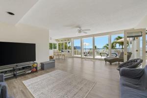 a living room with a flat screen tv and a couch at Marbella Lane - Luminous Seascape Ocean View in Malae