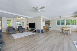 a living room with a ceiling fan and a table and chairs at Marbella Lane - Luminous Seascape Ocean View in Malae +21 photos