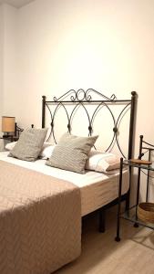 a bed with a black metal frame and pillows at Atico con Piscina en Ametlla de Mar in L'Ametlla de Mar +69 photos