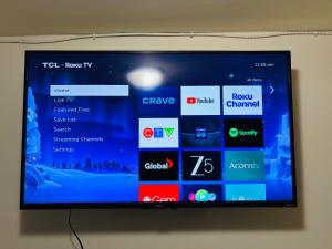 a television screen on a wall with different apps at UofC-SAIT-Banff Trail-Suite A&B in Calgary