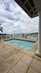 a swimming pool on a balcony of a building at Holland Manor in Durban