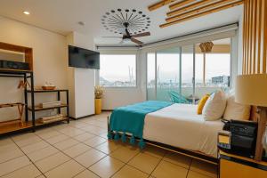 a bedroom with a large bed and a large window at Mayan Monkey Los Cabos - Social Hostel in Cabo San Lucas