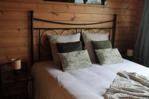 a bedroom with a bed with white sheets and pillows at A la campagne in Gouvy