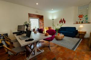 a living room with a table with a laptop on it at 7 Toritos Hotel Boutique by Hacienda in Cusco