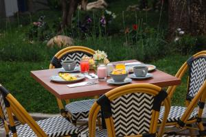 a wooden table with plates of food on it at 7 Toritos Hotel Boutique by Hacienda in Cusco +99 photos