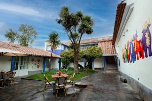 a patio with a table and chairs in front of a building at 7 Toritos Hotel Boutique by Hacienda in Cusco