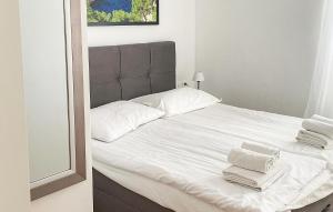 a large white bed with white towels on it at Cozy Apartment In Dingac With Outdoor Swimming Pool in Gornji Dingač