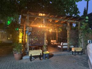 a wooden pergola with a bench and a table at Stylish Modern Elegance Deluxe Suite in Lagos