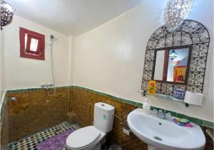 a bathroom with a sink and a toilet and a mirror at Riad Iman in Fès +20 photos