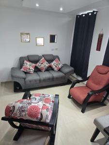a living room with a couch and a chair at Luxury five in Villavicencio