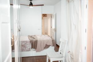 a bedroom with a bed and a mirror at Casa Oceanchild - Terraza con Vista Mar, Morro Jable in Morro del Jable