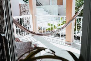 a hammock on the balcony of a house at Casa Oceanchild - Terraza con Vista Mar, Morro Jable in Morro del Jable