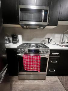a kitchen with a stove with a red towel on it at Downtown Private Room Central Location in Toronto +34 photos