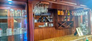 a bar with glasses on the wall of a store at Belo Résidence in Cap-Haïtien