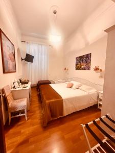 Postel nebo postele na pokoji v ubytování Soggiorno Madrid