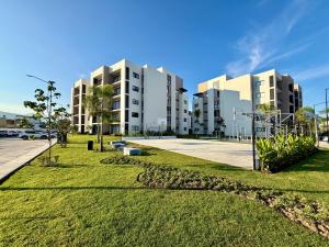 a row of apartment buildings in a parking lot at Modern Luxury Residency at Altea-Sunset Pool View in Puerto Vallarta