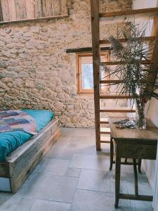 una camera da letto con un letto, un tavolo e una finestra di Al Foér Guesthouse ad Averara Altre 17 foto