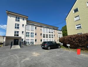 a car parked in a parking lot in front of a building at 36 Nürburgring in Mayen in Mayen
