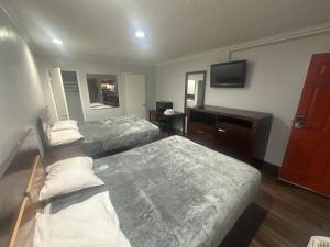 Ένα ή περισσότερα κρεβάτια σε δωμάτιο στο Heritage Inn