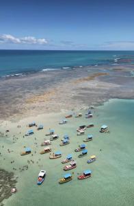 a group of boats in the water on a beach at Casa providencial in São Miguel dos Milagres