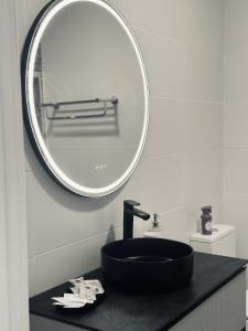 a bathroom with a black sink and a mirror at VV Abrante in La Restinga +13 photos