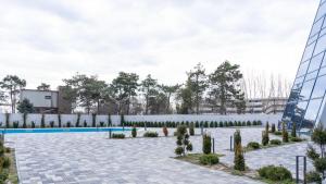 a courtyard of a building with a pool and trees at Sea La Vie in Mangalia