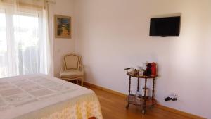 Μια τηλεόραση ή/και κέντρο ψυχαγωγίας στο Casa da Alegria Boutique Guest Suite +17 φωτογραφίες