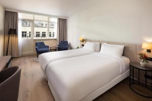 Postel nebo postele na pokoji v ubytování NH Atlanta Rotterdam Hotel