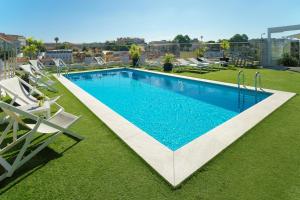 a swimming pool on the roof of a building at NH Collection Lisboa Liberdade in Lisbon