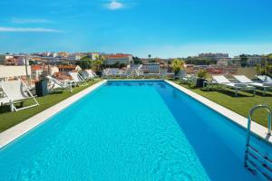 a swimming pool on the roof of a building at NH Collection Lisboa Liberdade in Lisbon
