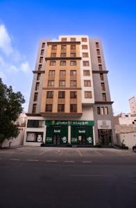 a tall building with a store in front of it at HDN Hotel فندق هدن in Mecca