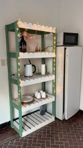 a kitchen with a green shelf next to a refrigerator at Departamento a media cuadra de la plaza principal in Tandil