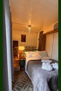 a bedroom with a bed with two pillows on it at Pousada Quinta das cores in Urubici