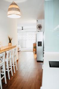 a kitchen with a white refrigerator and a table at Casa Oceanchild - Terraza con Vista Mar, Morro Jable in Morro del Jable