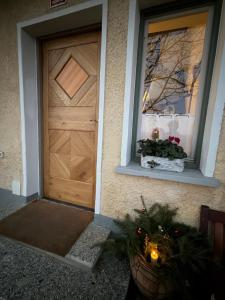 Una puerta de una casa con dos ventanas y una planta. en Haloze Chill, en Podlehnik