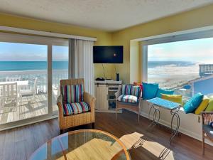 a living room with a view of the ocean at Ocean Dunes 306 in Kure Beach