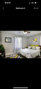 a bedroom with a large bed and a window at Cozy Vintage Ranch in Fayetteville
