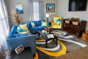 a living room with a blue couch and a table at Cozy Vintage Ranch in Fayetteville