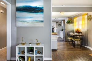 a dining room and kitchen with a painting on the wall at Cozy Vintage Ranch in Fayetteville