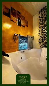 a white bath tub in a bathroom with a window at Pousada Quinta das cores in Urubici
