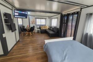a living room with a couch and a dining room at The Country Nook in Manildra
