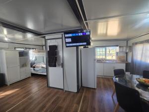 a kitchen and dining area of a rv with a television at The Country Nook in Manildra