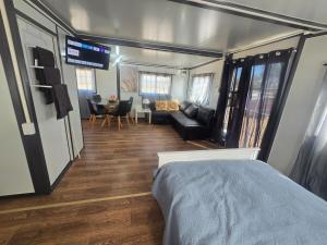 a room with a bed and a living room at The Country Nook in Manildra