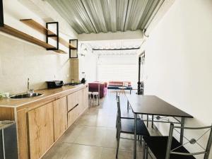 a kitchen with a table and a dining room at Hostal Bon Hábitat in Yopal