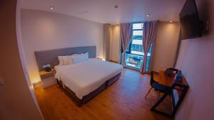 a bedroom with a large bed and a large window at Hotel de Turistas Iquitos in Iquitos +81 photos