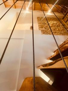 a staircase in a room with wooden floors at Al Foér Guesthouse in Averara