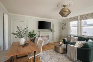 a living room with a green couch and a table at Chic Georgian Escape near Royal Crescent in Bath
